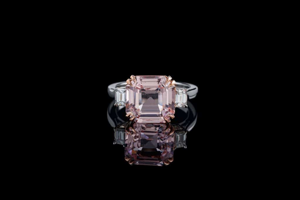beautiful gold ring with morganite and diamond gemstones on a black background close-up