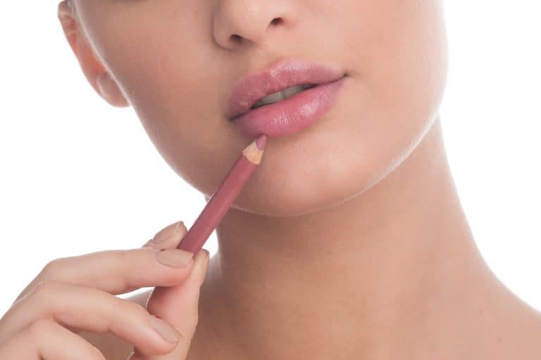 woman applying nude lip liner. Should Lip Liner Match Lipstick