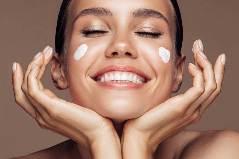 Beautiful woman applying cream on her face, 10 Best Night Creams With Hyaluronic Acid