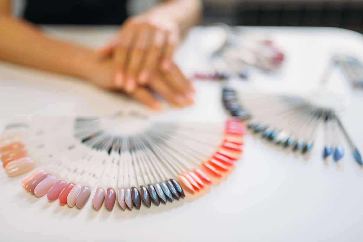Different colored nail design templates on a table