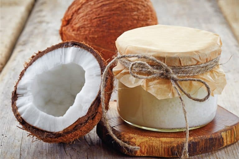 Jar of coconut oil and fresh coconuts. How To Make Body Scrub With Coconut Oil [Including 5 Effective Recipes]