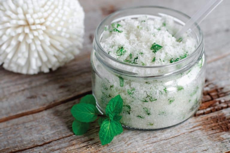 home made sugar body scrub with mint leaves in a wide mouth glass bottle. Do You Use Body Scrub Before Or After Soap
