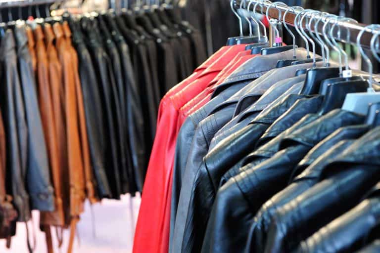 A row of colorful leather jackets hanging on hangers in retail shop, Should You Dry Clean A Leather Jacket?