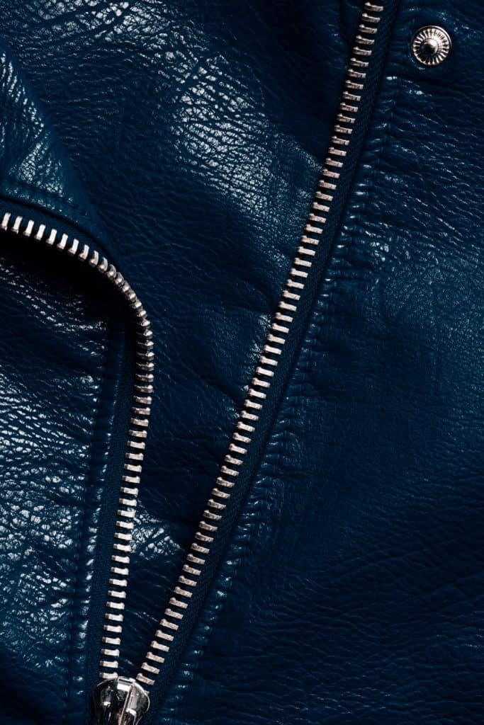 An up close photo of a leather jacket zipper