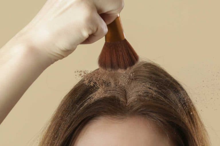 Close up view at woman applaying natural dry shampoo on hair roots, Do You Use Dry Shampoo Before Or After Styling?