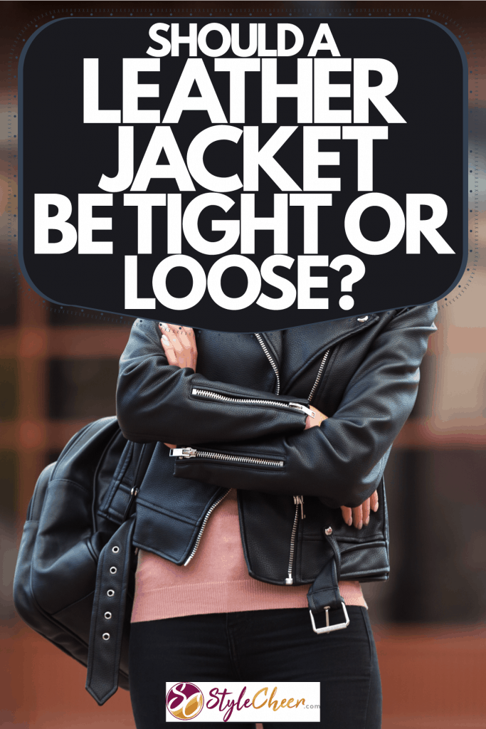A woman wearing a leather jacket and scarf in the cold New York weather, Should A Leather Jacket Be Tight Or Loose?
