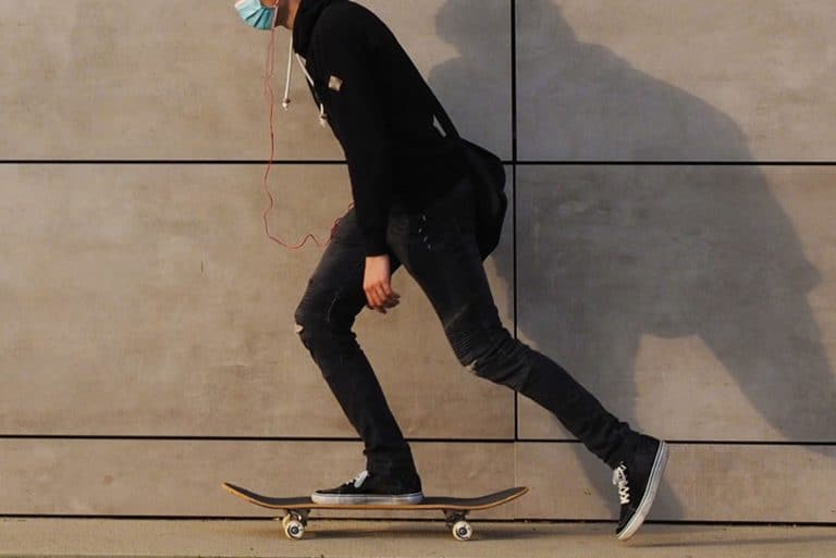 View of a young man skateboarding in the urban environment wears black jeans and black shoes, What Color Shoes To Wear With Black Jeans?