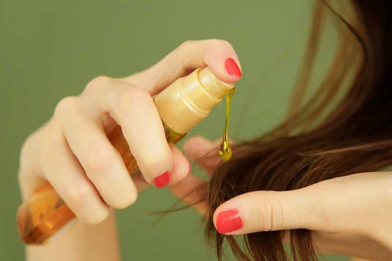 Woman applying hair serum on her hair ends, 11 Types Of Hair Serum To Know