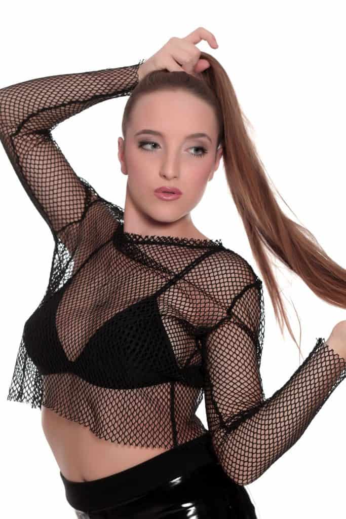 A beautiful model wearing a net outfit and faux leather pant