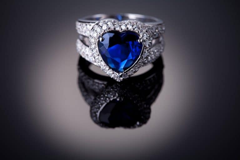 A blue sapphire cut precisely and cut into a diamond with embedded diamonds on the frame, Do Sapphires Get Cloudy?