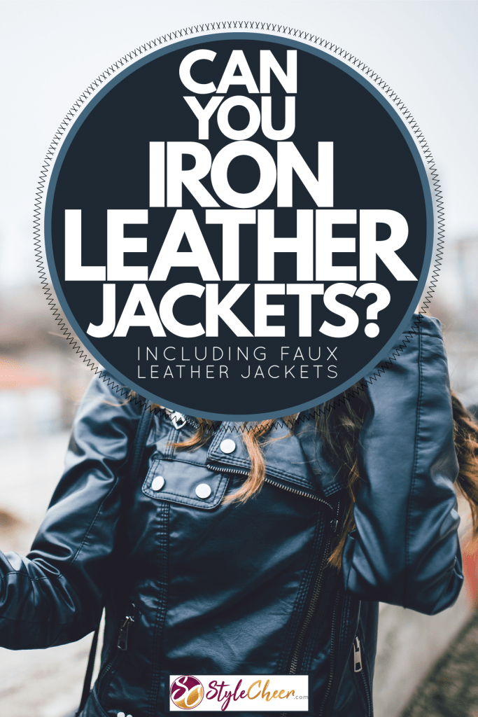 A woman holding a mirror wearing a leather jacket, Can You Iron Leather Jackets? [Including Faux Leather Jackets]