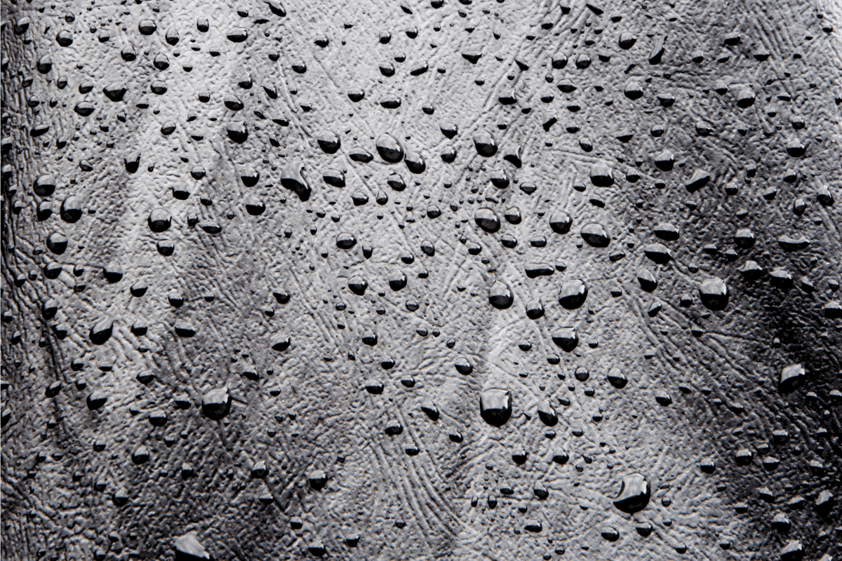 Water droplets on black leather material.