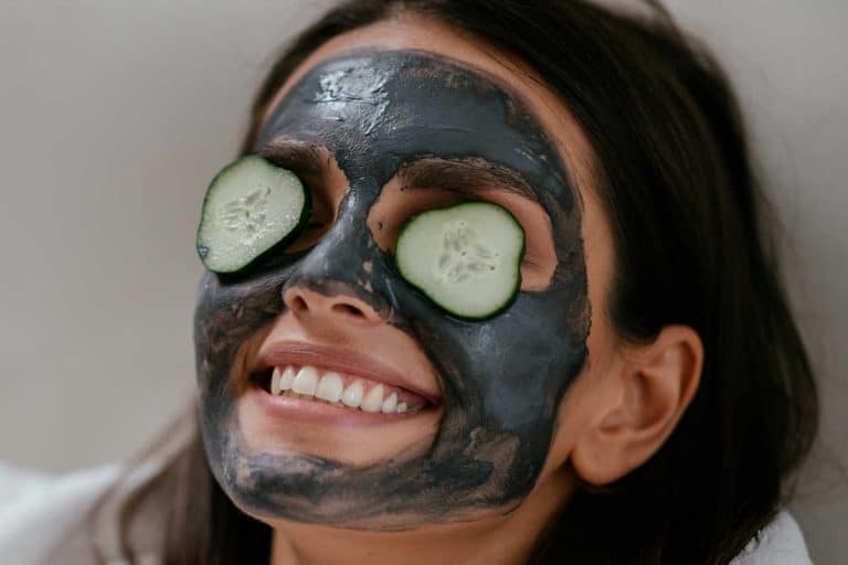 A women applying mud mask and cucumber on the face, Can I Use A Dead Sea Mud Mask Everyday?