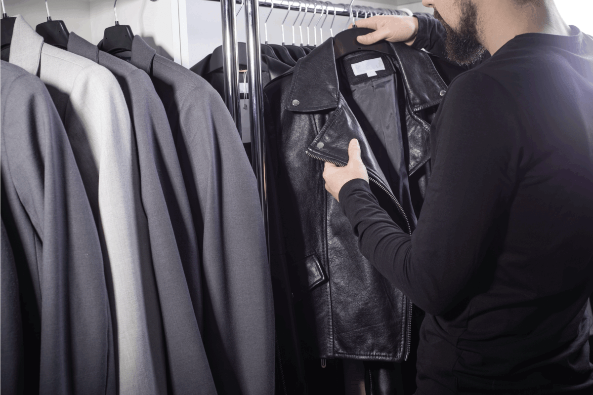 man choosing leather jacket on a department store