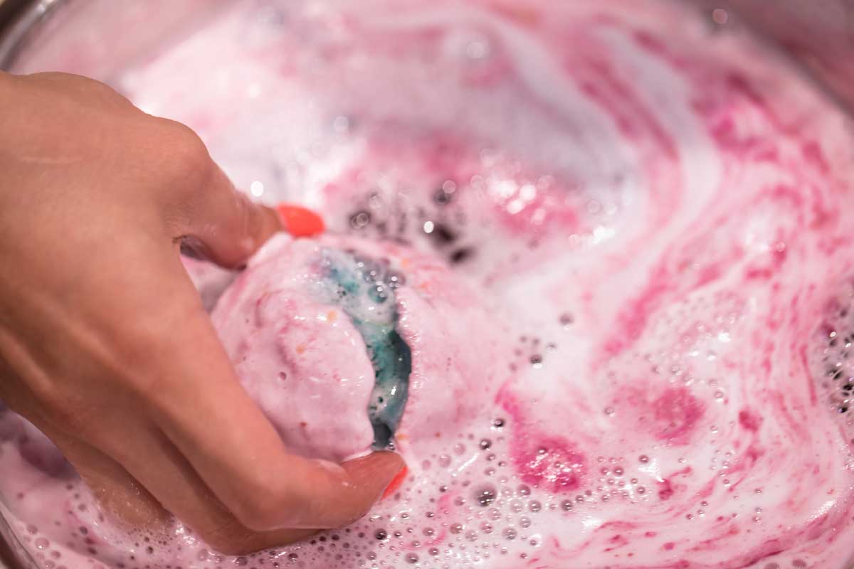 Bright natural fizzy bath bomb dissolves in the hand, How Big Is A Bath Bomb? Should You Use It Whole Or Cut It In Half?