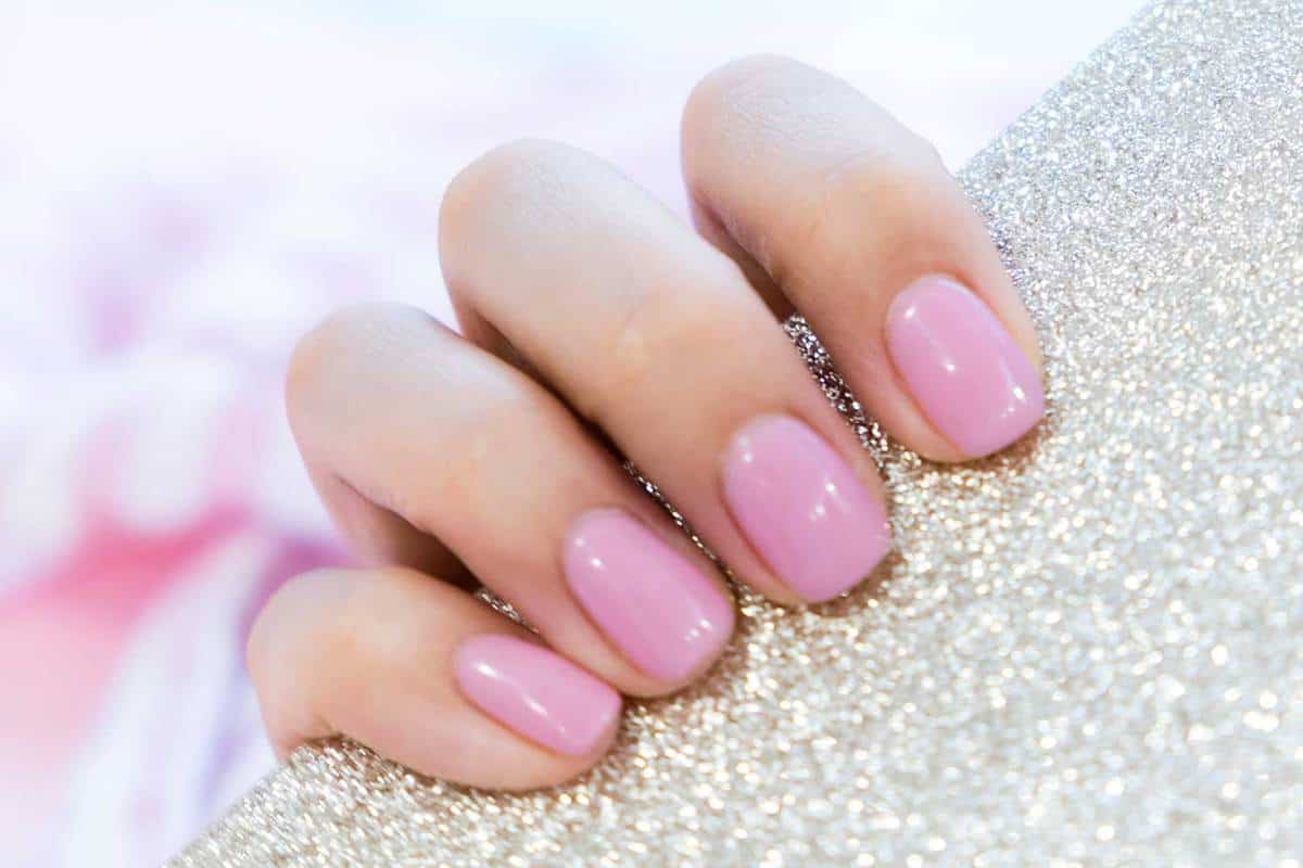 Close up of a female with pink manicured fingernails