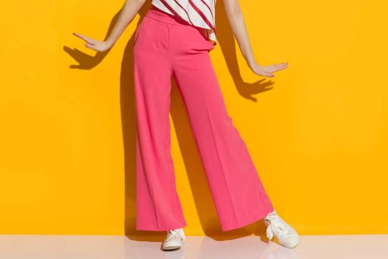 Excited young woman in pink wide leg trousers, How Much Fabric Do You Need For Palazzo Pants?