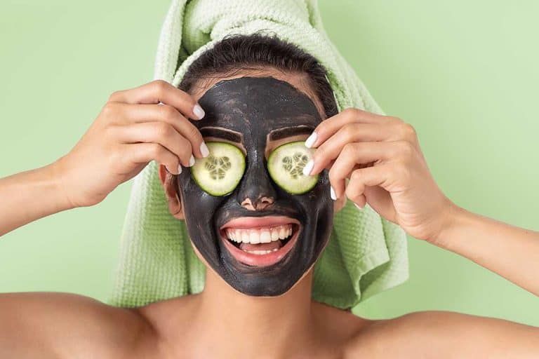 Happy smiling girl applying facial carbon mask, Should You Moisturize After A Charcoal Mask?