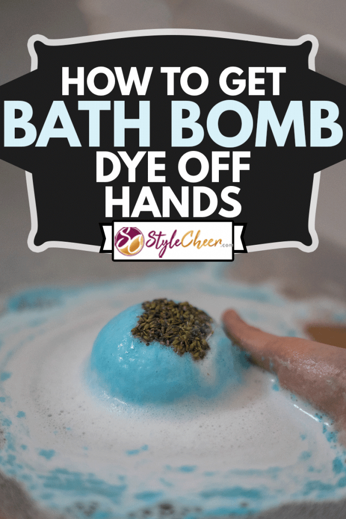 Hand taking a blue bath bomb dissolving in the bathtub, How To Get Bath Bomb Dye Off Hands