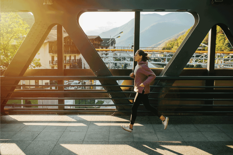 lady taking a short jog on a bridge wearing windbreaker and yoga pants. Are Yoga Pants Business Casual