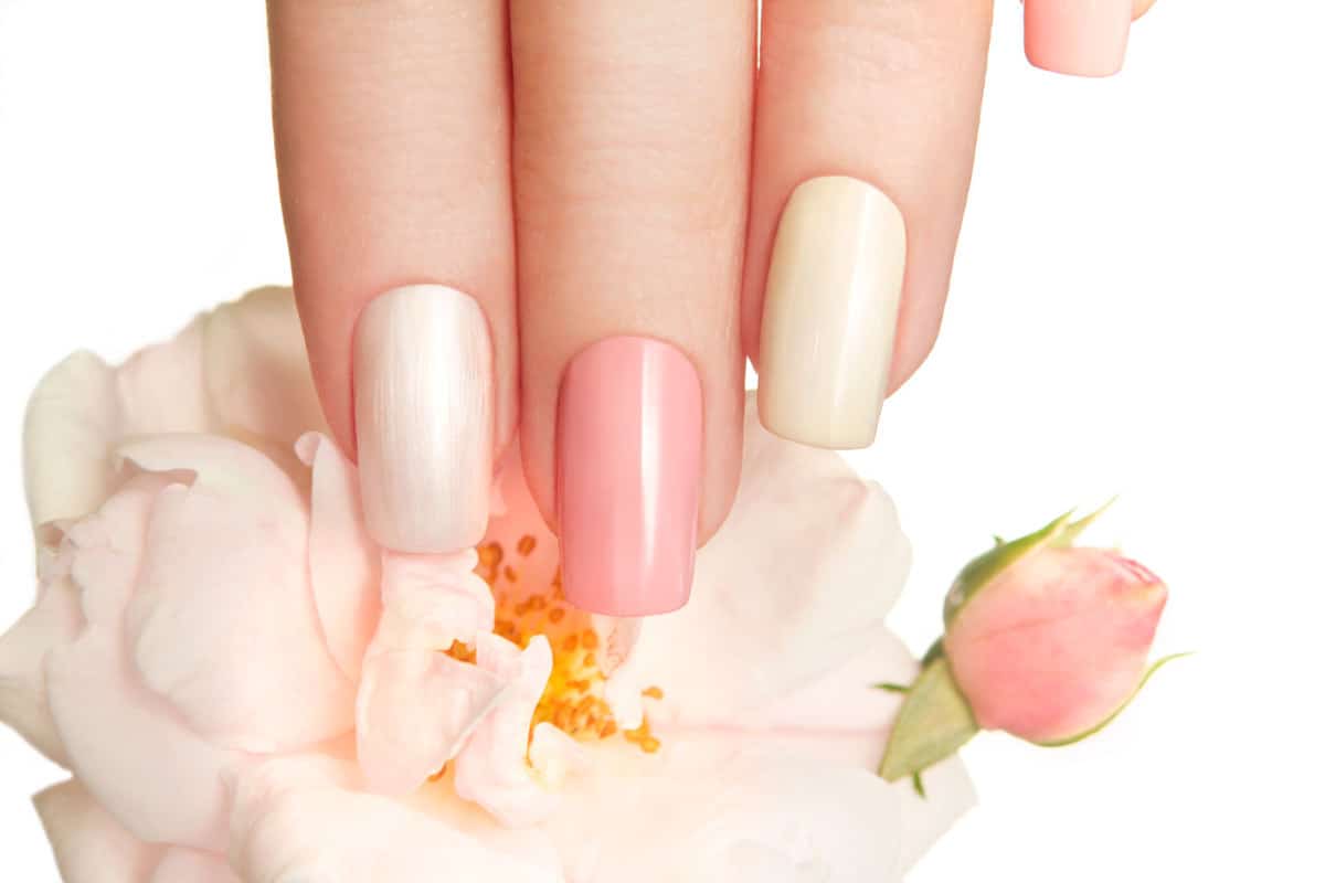 A woman showing her pale finger and gorgeous light tints of pink