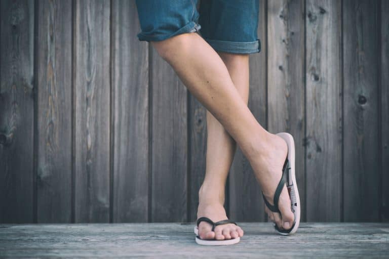 A woman wearing jean short and flip flops, How To Keep Flip Flops From Slipping Off