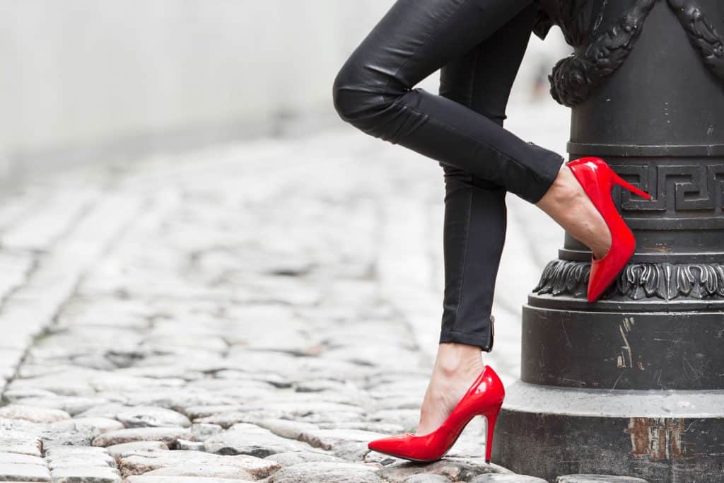 A woman wearing red sandals and leather pants, Do Leather Pants Stretch? [Inc. Faux Leather]