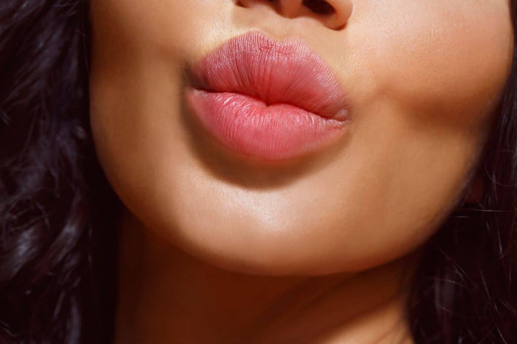 Close up, natural lips. Beautiful and fresh young woman
