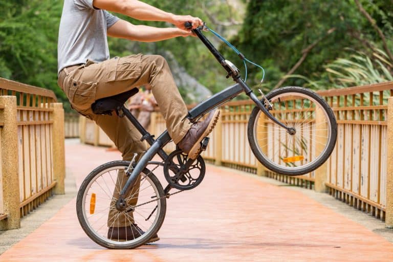 Man wearing cargo pants and his bicycle, How Long Should Cargo Pants Be?