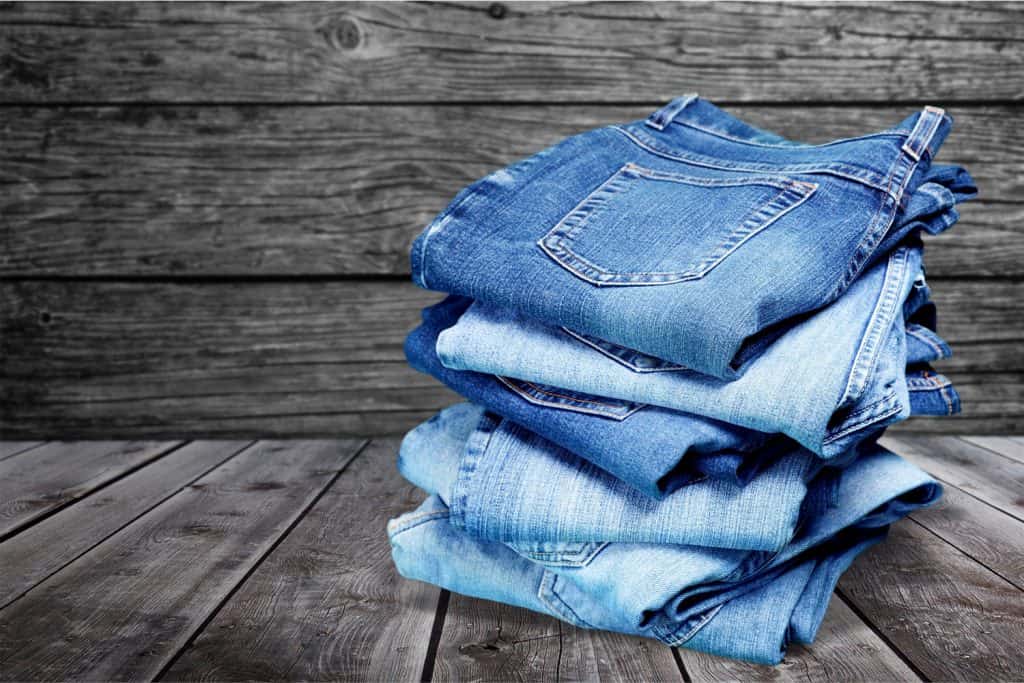 Stack of jeans isolated on white background, Do Jeans Shrink Or Stretch?