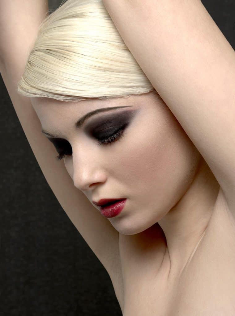 Blonde woman with smokey dark eyeshadow makeup on eyes