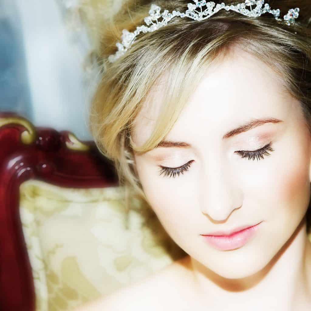 A beautiful blonde woman wearing a small crystal crown