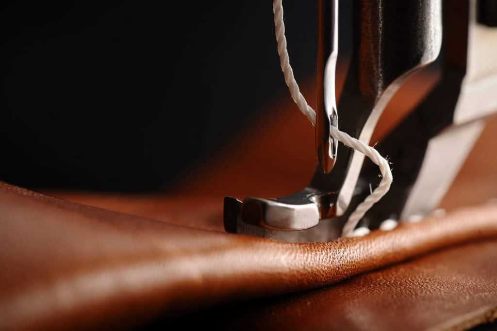 A sewing machine sewing a genuine leather
