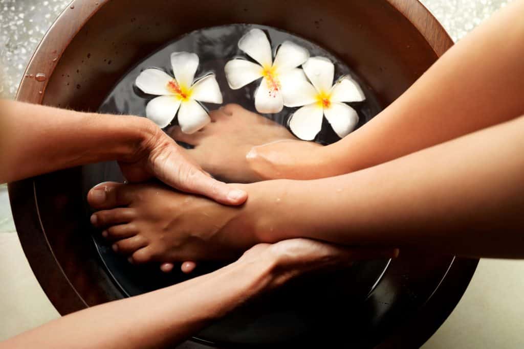 A woman getting her foot massage in the spa