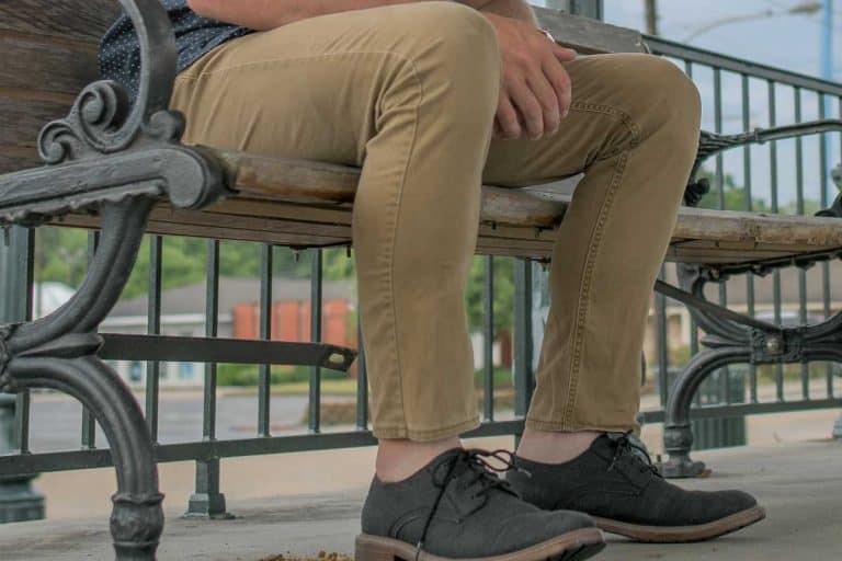 Man sitting on the bench wearing khaki pants and black leather shoes, What Color Shoes Go With Khaki Pants?