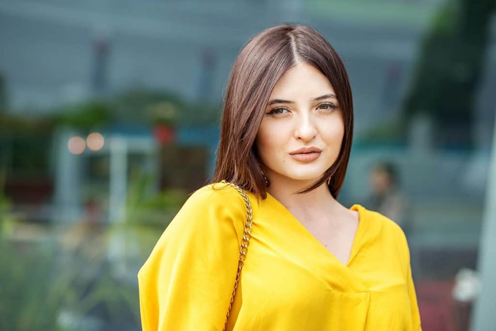 Portrait of a young beautiful woman in yellow clothes