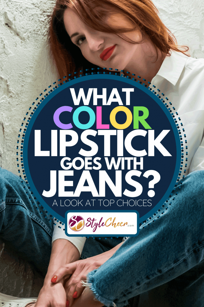 A woman with red lips in jeans and white shirt sits on wooden bench, What Color Lipstick Goes With Jeans? [A Look At Top Choices]