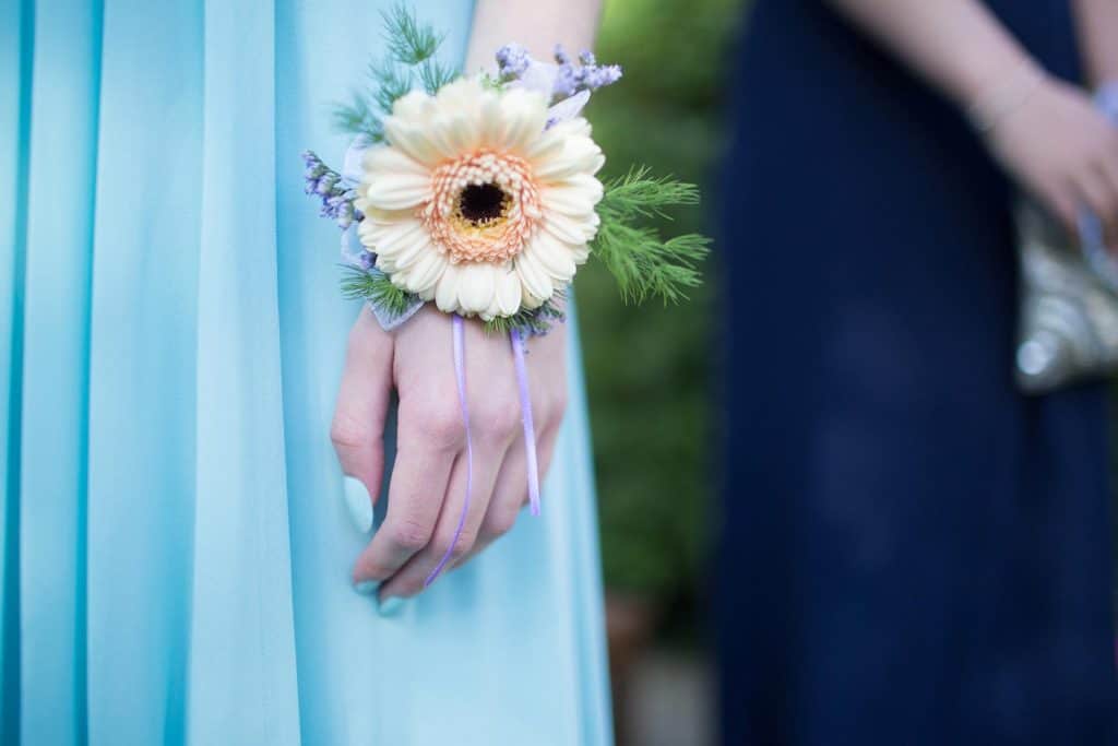Girl wearing a powder blue dress with a corsage