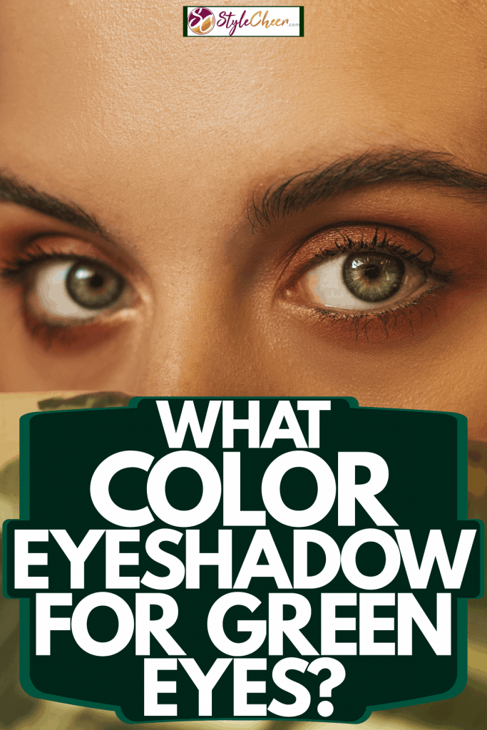 A woman looking at the camera with intent with her green eyes and dark brown eyeshadow, What Color Eyeshadow For Green Eyes?