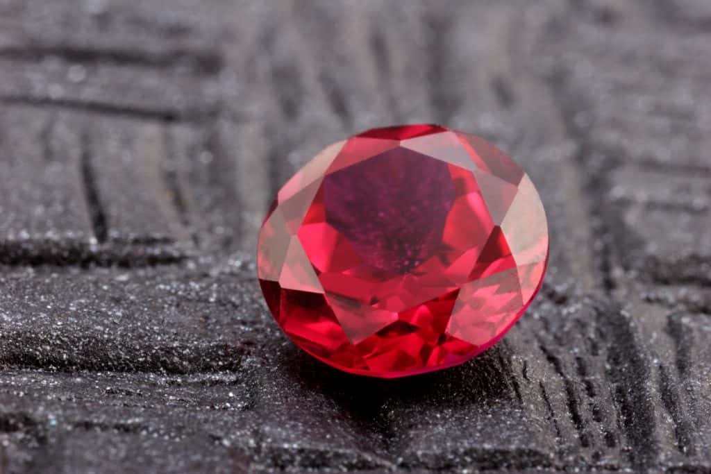 A gorgeous and neatly cut ruby gemstone on a table