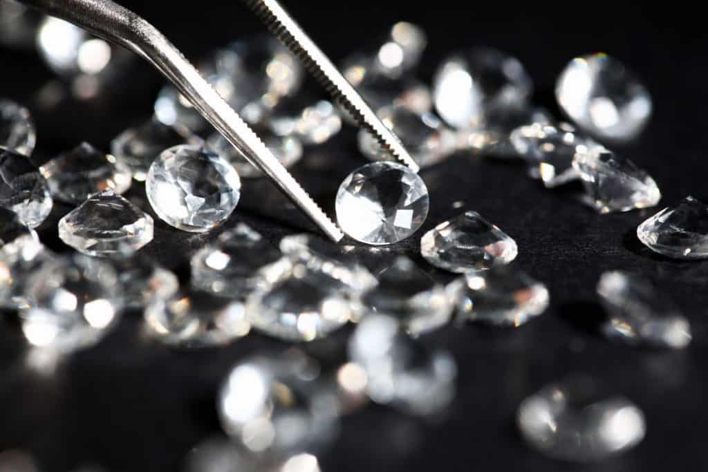 A jewelry expert handpicking diamonds