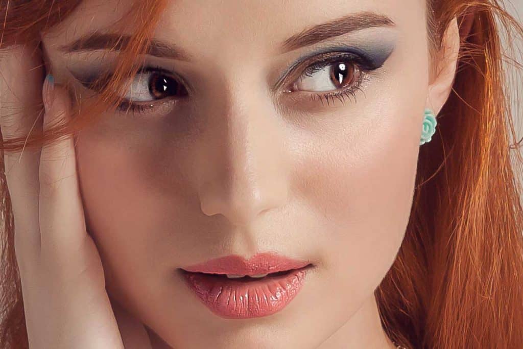 A beautiful portrait of a woman with copper hair, What Color Lipstick Goes With Copper Hair?