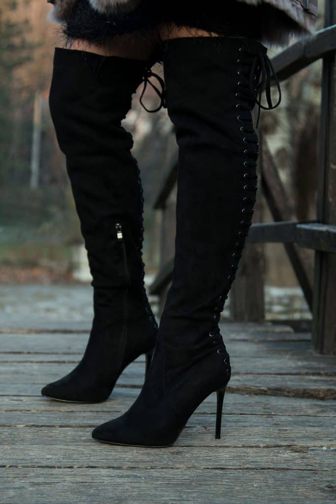 Black thigh high boots worn by a woman