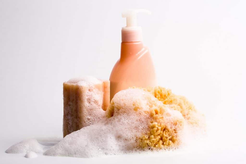 Photo of soap, natural sponge and shower gel