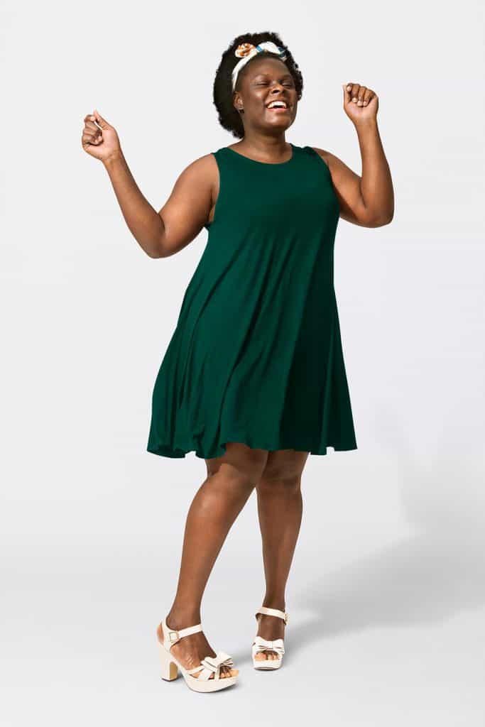 African American woman wearing green tent dress