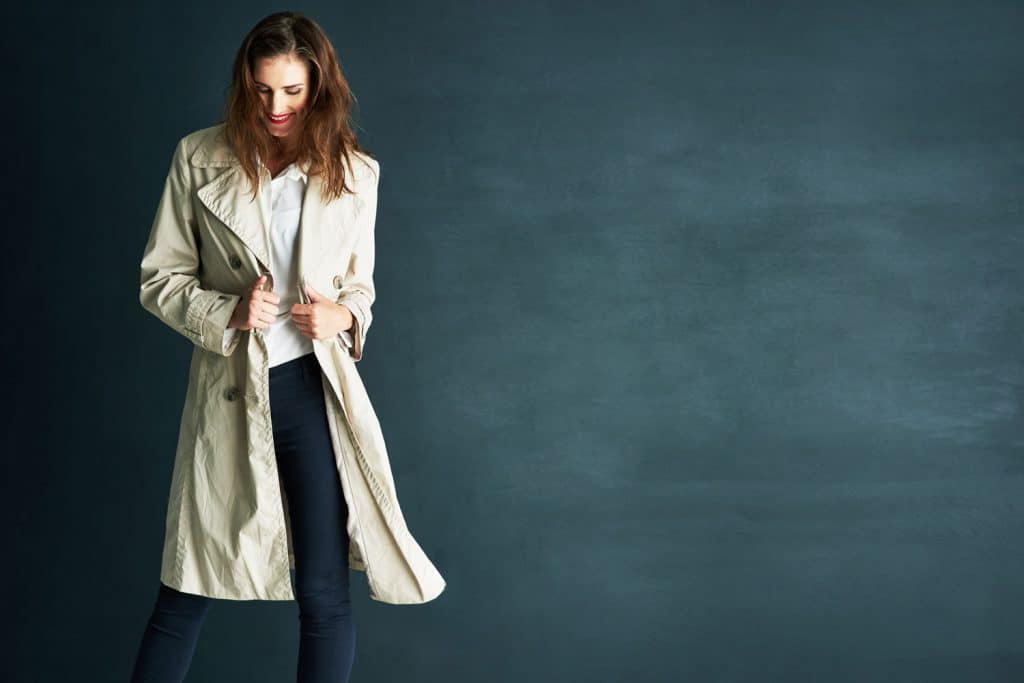 A beautiful woman posing and showing her gorgeous trench coat
