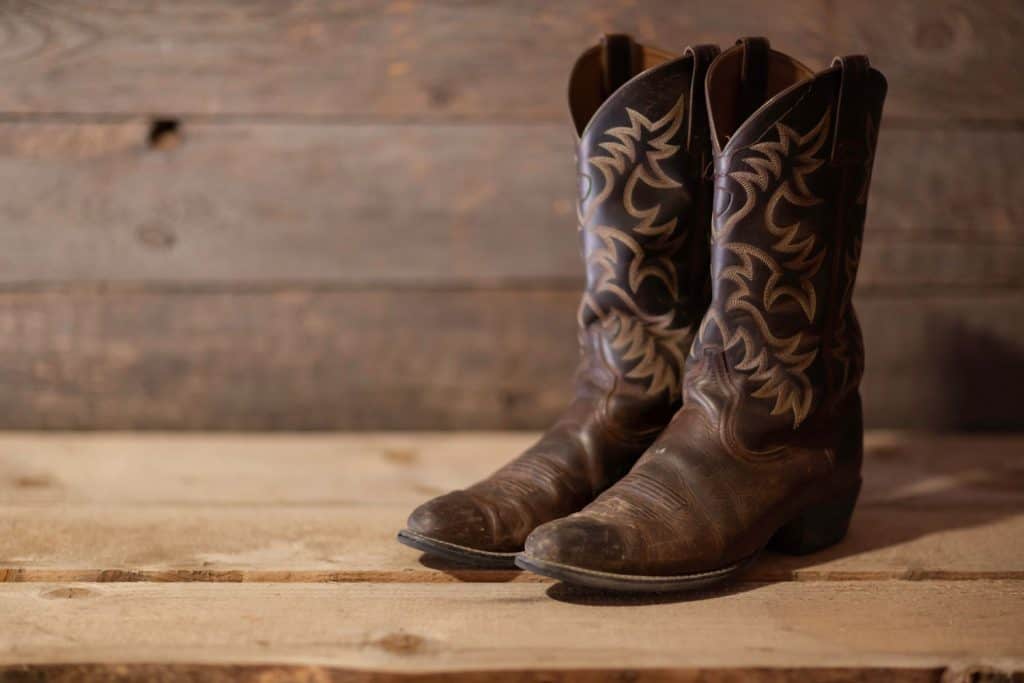 A pair of cowboy boots on the shelf