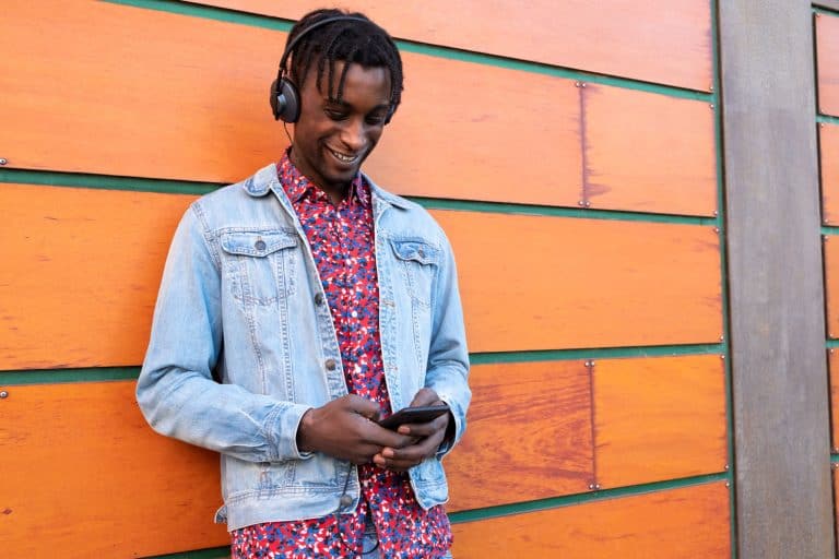 A tall handsome man wearing a denim jacket and headphones, What Colors Go With A Denim Jacket?
