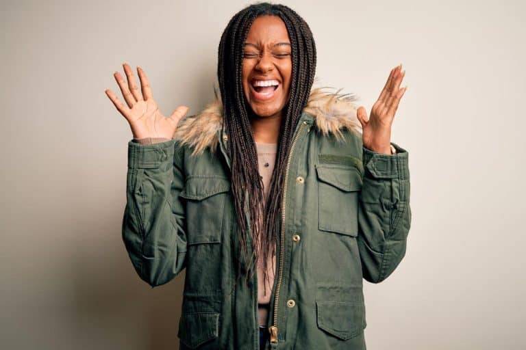 Young african american woman wearing winter parka coat, How Long Should A Parka Coat Be? [And How It Should Fit]