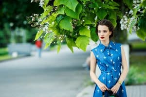 A beautiful woman wearing a blue dress with cross patterned design, What Color Accessories To Wear With A Blue Dress